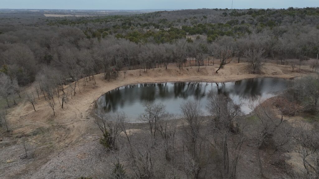 Aerial view of pond after brush clearing on tank dam occured.