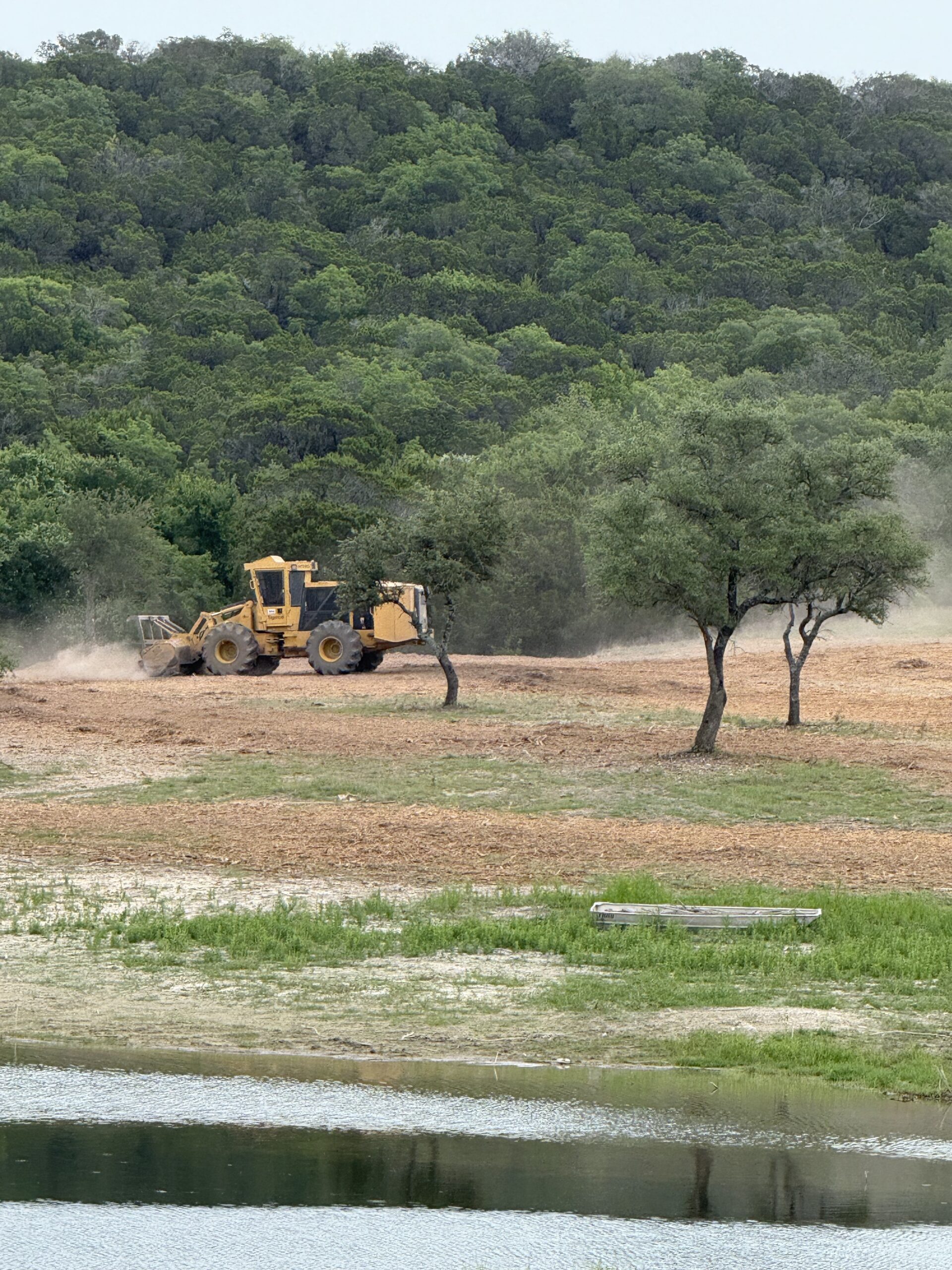 Cedar Eater grinding piles near private lake on ranch in Central TX.